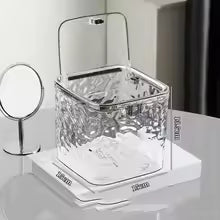 Clear acrylic hair accessories organizer storage box from Clarify.pk on a white surface with a small mirror