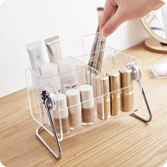 Clear acrylic remote control holder by Clarify.pk organizing makeup brushes and cosmetic tubes on a wooden surface
