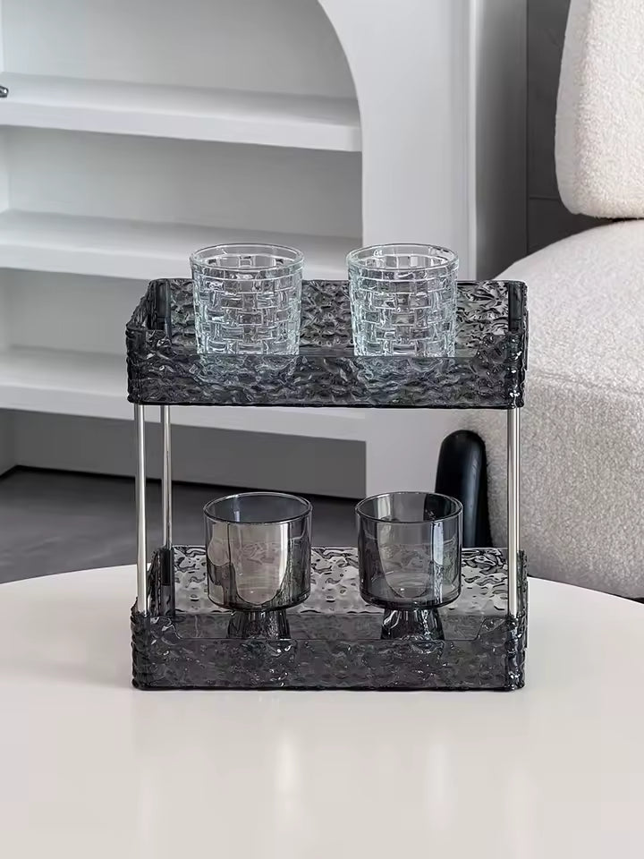 Clarify.pk black acrylic shower organizer with two tiers holding four glass cups on white table