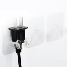 Black adhesive Wall Storage Hook holding a vacuum cleaner hose on a white wall
