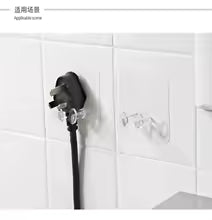 Black adhesive Wall Storage Hook mounted on white tiled wall holding a black electrical plug