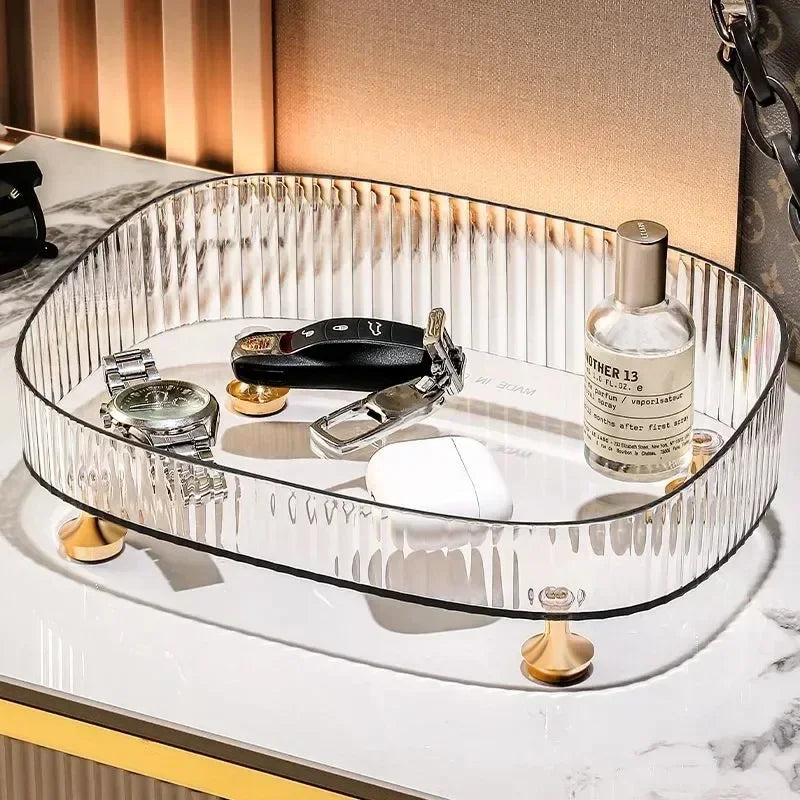 Clarify.pk transparent dresser storage box with gold legs holding watch keys nail clipper and perfume bottle