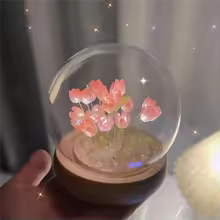 Artificial tulip night lamp with pink flowers encased in a clear glass dome with wooden base