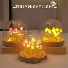 Artificial tulip night lamp with glowing flowers under glass dome on wooden base