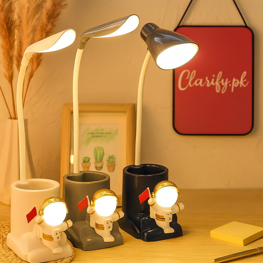Astronaut LED desk lamp with flexible neck and astronaut figurine base in white, gray, and black colors