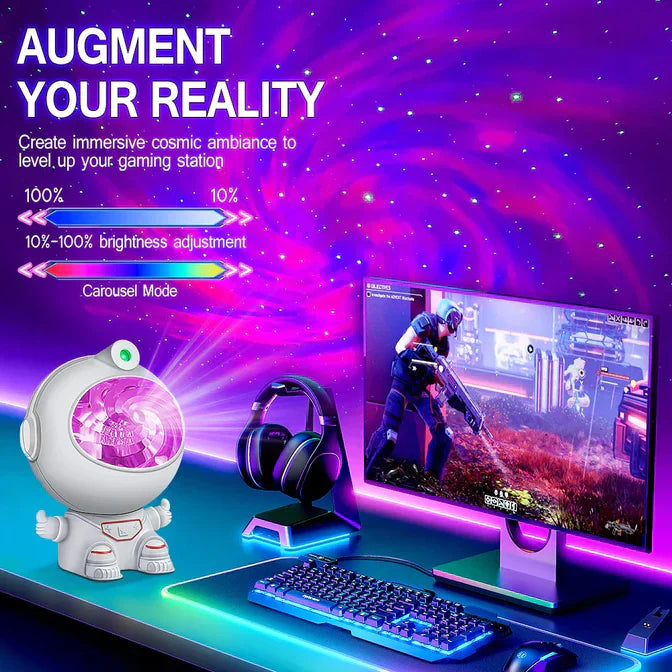 Astronaut star projector lamp on desk creating cosmic ambiance with gaming monitor keyboard and headphones