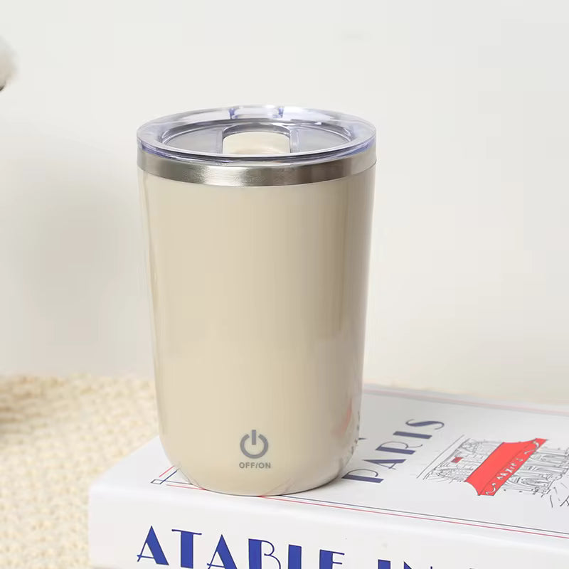 Clarify.pk beige automatic self stirring mug with transparent lid on a book