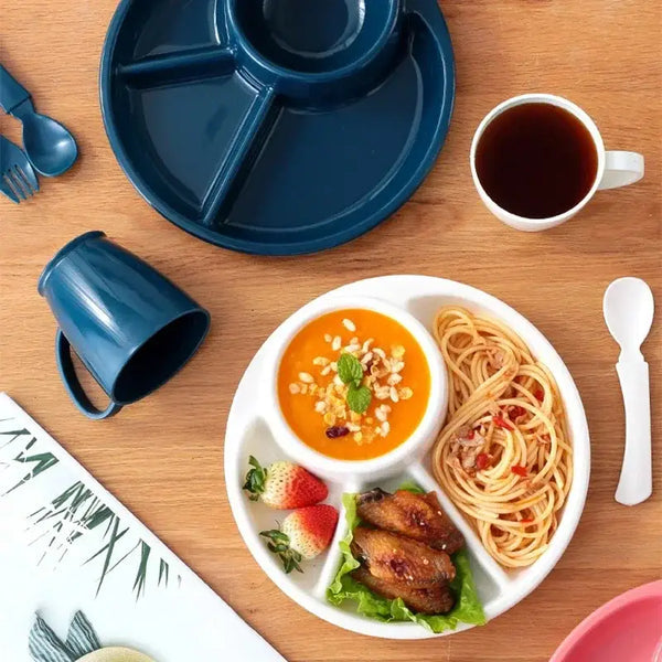 Clarify pk 4 compartment plastic dinner plate filled with spaghetti chicken wings strawberries and soup on wood table