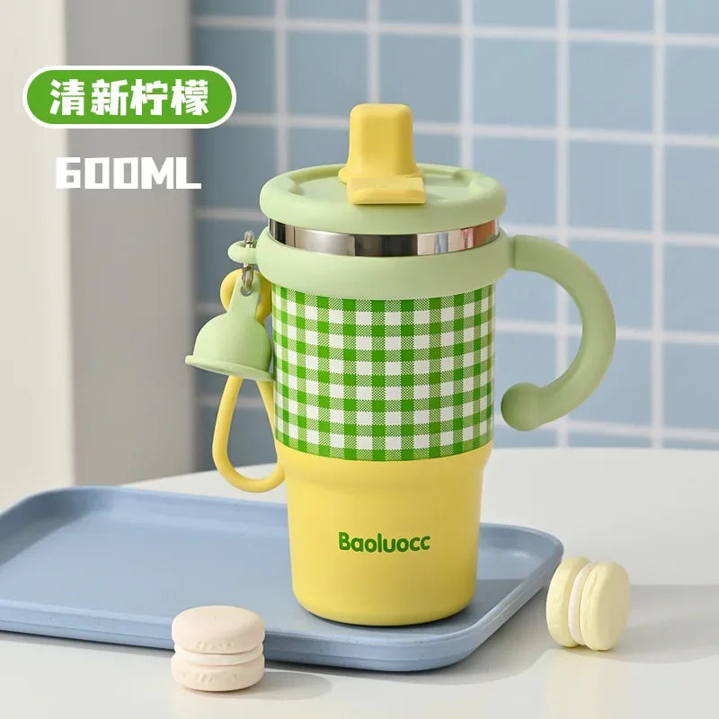 600ml stainless steel kids thermos with green checkered design and yellow base on a blue tray