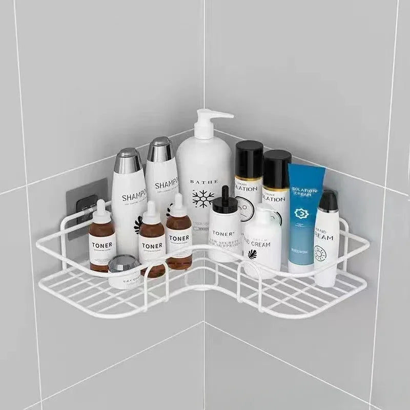 White bathroom corner shelf wall mounted holding skincare and shampoo bottles in tiled shower corner