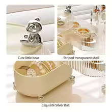 360 degree jewelry organizer with clear striped shelves, beige base, and cute bear design details