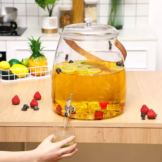 5.2L beverage dispenser with spigot filled with fruit-infused drink on wooden kitchen countertop