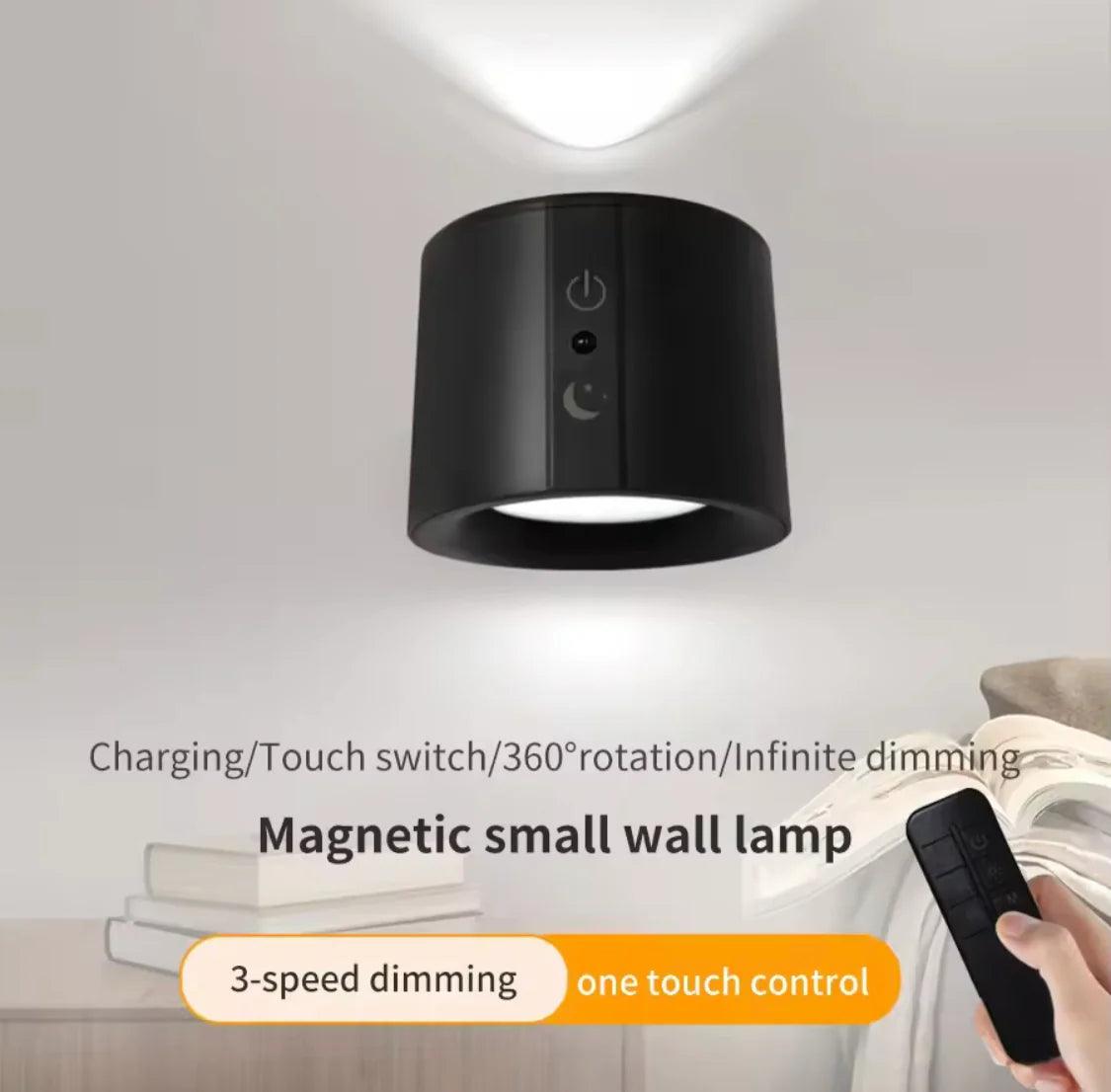 Black magnetic 360 degree LED wall lamp with touch switch and remote control on white wall