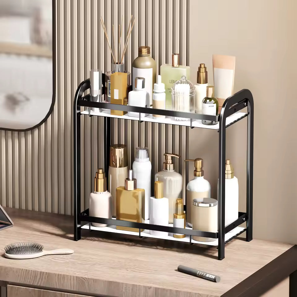 Clarify.pk 2 tier bathroom counter organizer in black metal holding various skincare and beauty bottles