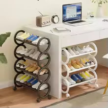 4 layer shoe rack with rollers by Clarify.pk holding various shoes beside a white desk