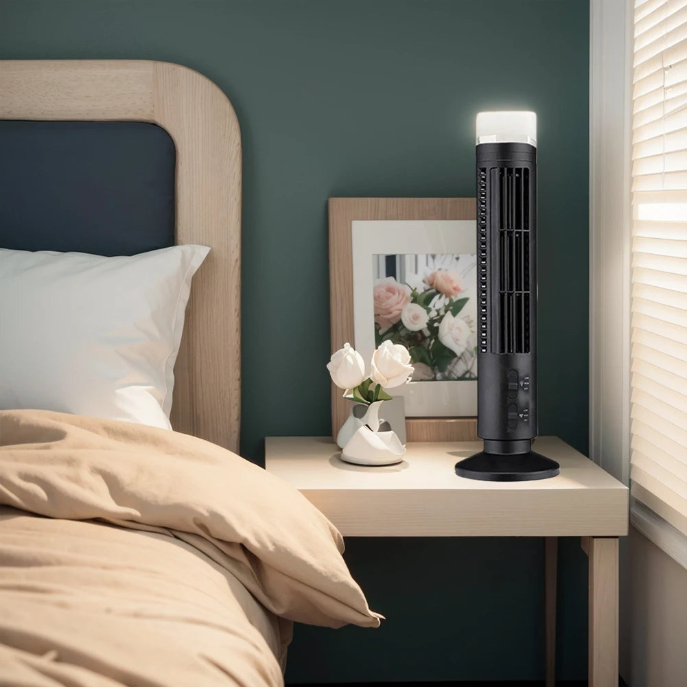 Black bladeless desktop tower fan on bedside table with beige bed and curtains