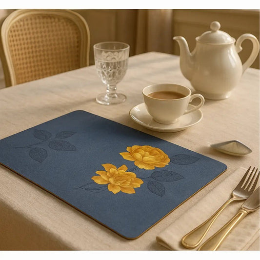 Blue and gold placemats for dining table with floral design set on beige tablecloth