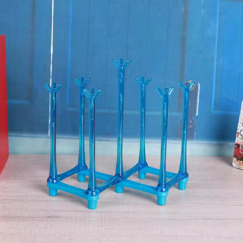 Blue plastic glass cup drying rack with multiple prongs for holding cups securely on a wooden surface