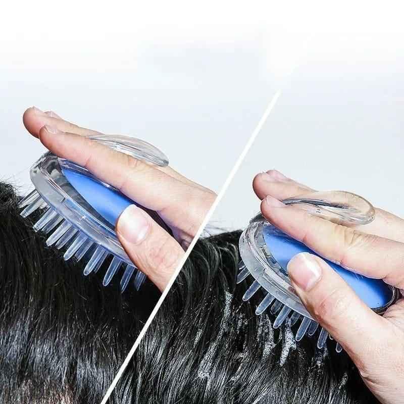 Clear and blue silicone scalp massage brush held in hand used on wet hair for scalp stimulation