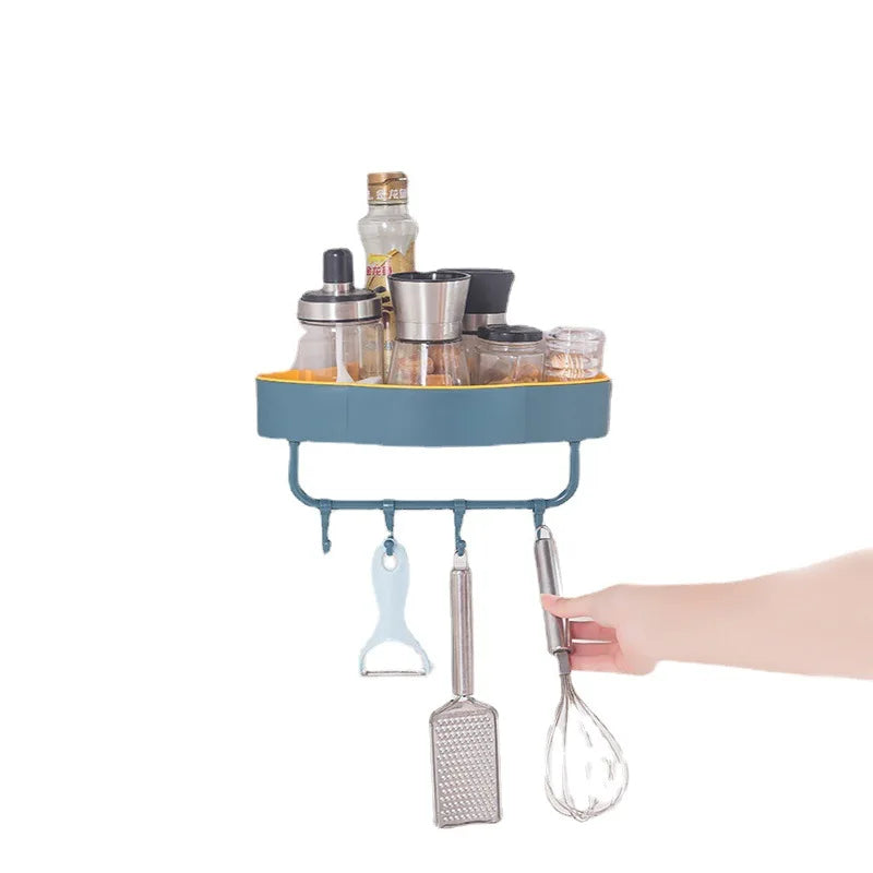 Clarify.pk wall-mounted corner shower shelf in blue holding various kitchen tools and bottles with hanging hooks