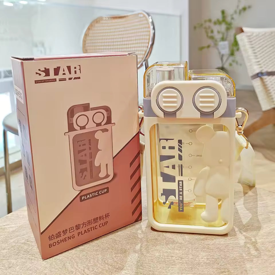 Clarify.pk cartoon bear water bottle with clear yellow plastic and matching box on table