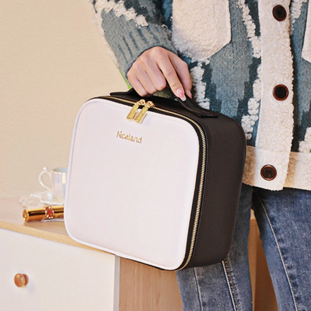 Smart LED makeup case with mirror in black and white held by a person wearing a patterned sweater and jeans