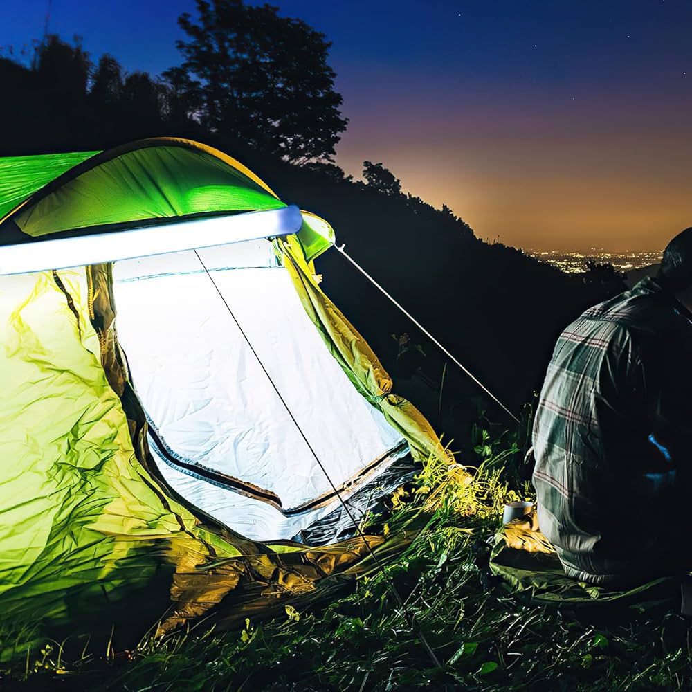 Clarify.pk camping inflatable light inside green tent glowing at night with person sitting nearby