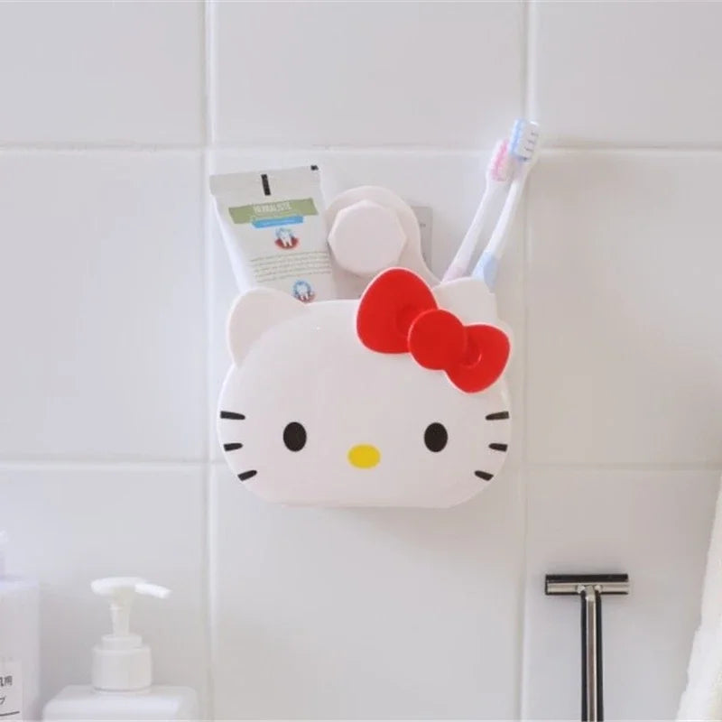 Cartoon bathroom organizer wall mount shaped like a white cat with a red bow holding toothbrush and toothpaste