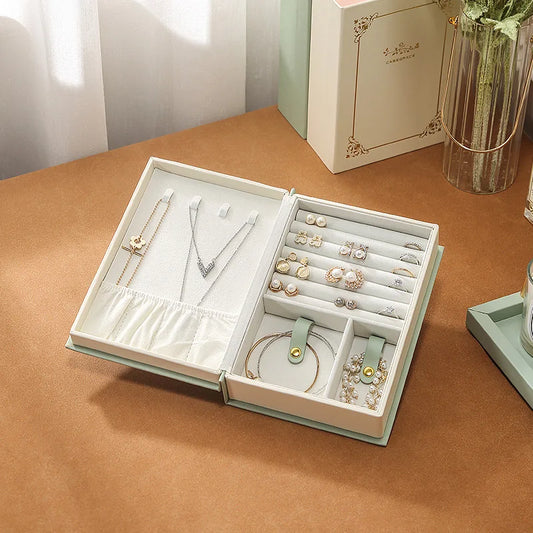 PU leather necklace and bracelet case opened to display organized jewelry including rings, earrings, and necklaces