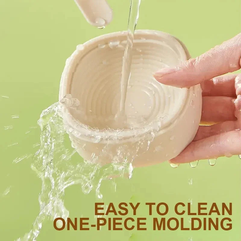 Hand holding a cat paw ice cream mold pack of 2 being washed with water showing easy to clean feature