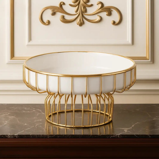 White ceramic pedestal bowl with stand featuring gold metal frame on marble surface