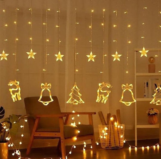 Christmas star fairy lights with hanging stars, bells, reindeer, and tree decorations in a cozy living room