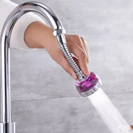 Clarify.pk 360 degree rotating kitchen faucet nozzle attached to a chrome kitchen faucet with water flowing