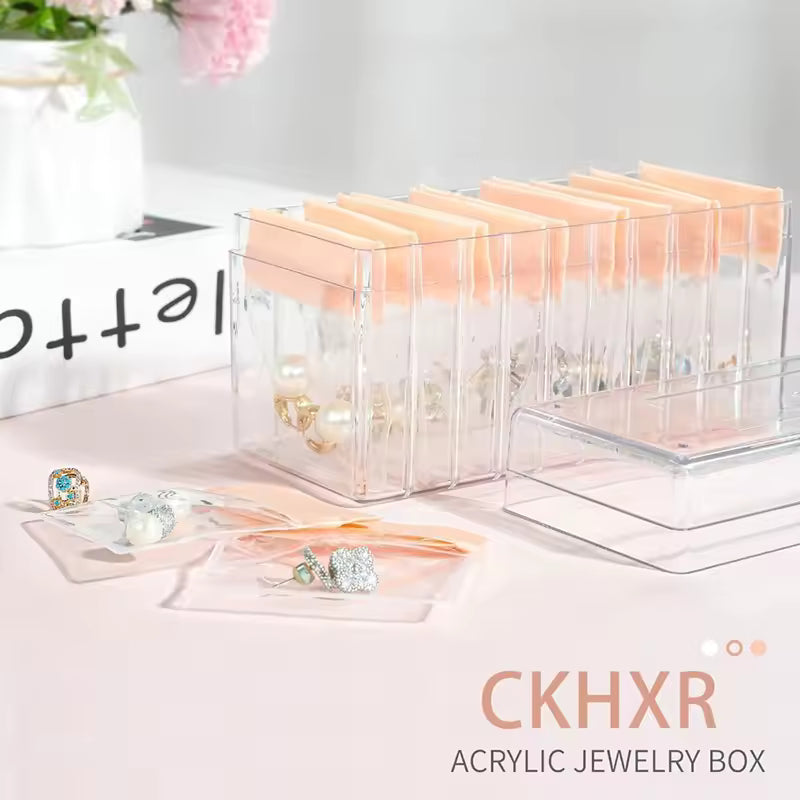 Clarify.pk acrylic jewelry box with multiple compartments and peach inserts for organized jewelry storage