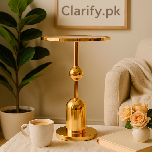 Luxury gold pedestal stand with a modern design displayed on a table beside a coffee cup and flowers