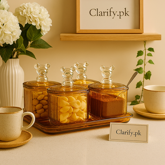 Amber glass storage jars set with clear bear-shaped lids on wooden tray by Clarify.pk