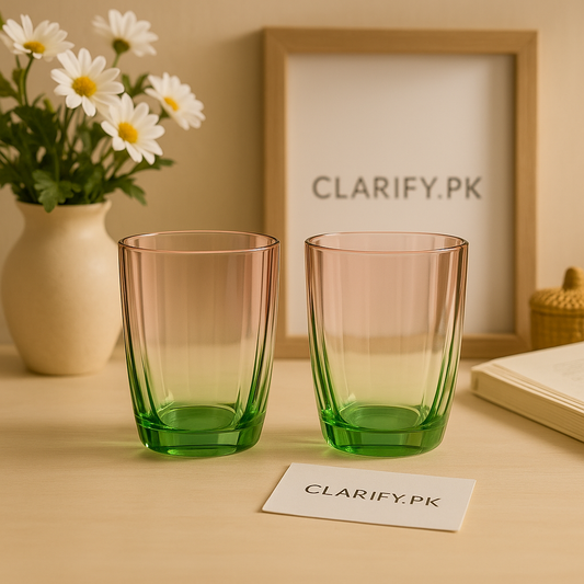 Set of two luxury pink and green glass tumblers with ombre gradient on wooden table with daisies