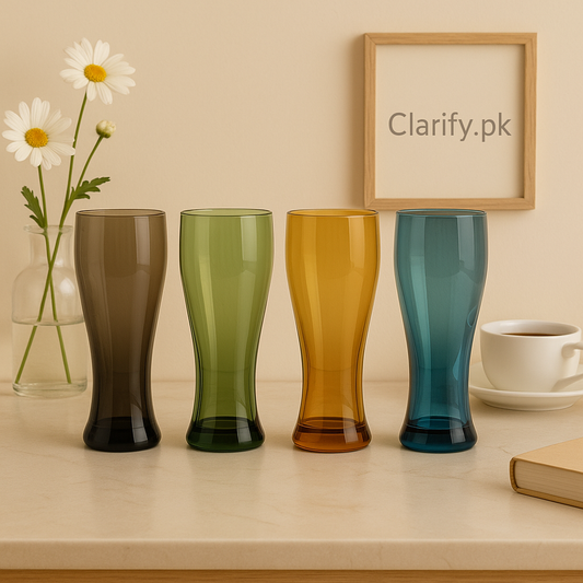 color-tinted pilsner glass set of four in smoky gray green amber and teal displayed on a countertop