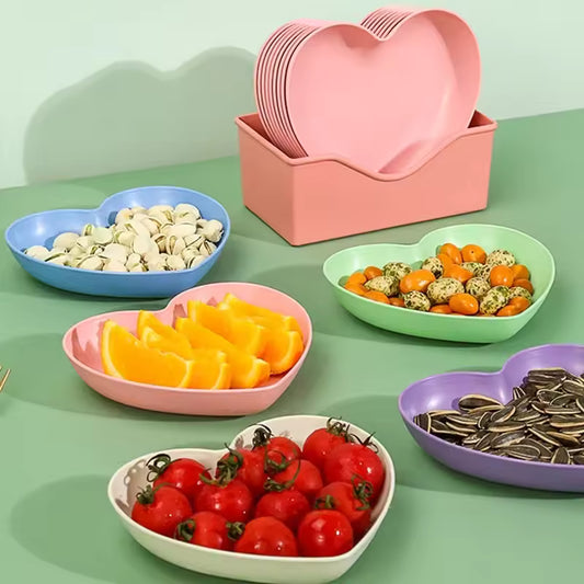 Colorful heart dish pack of plastic plates by Clarify.pk holding fruits and snacks