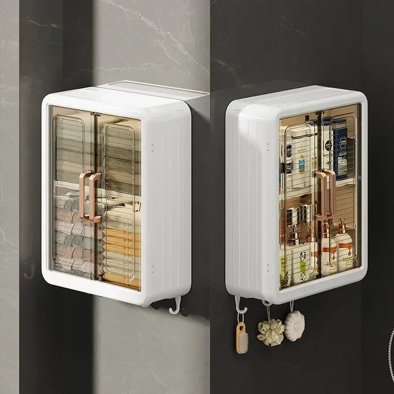 White wall mounted bathroom storage cabinet with transparent doors and rose gold handles holding toiletries and towels