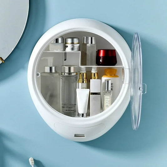 White wall-mounted cosmetic storage box with clear door holding various skincare and beauty products