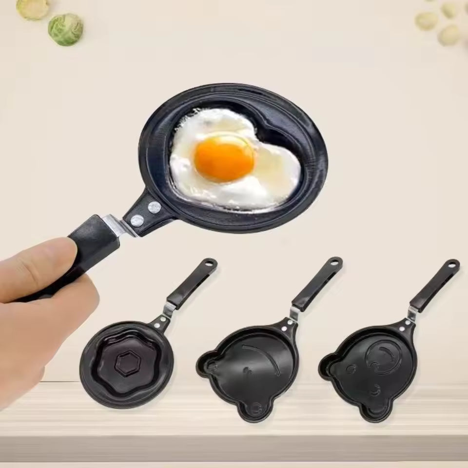 Creative cartoon mini omelette pan with black handle cooking a fried egg in heart shape
