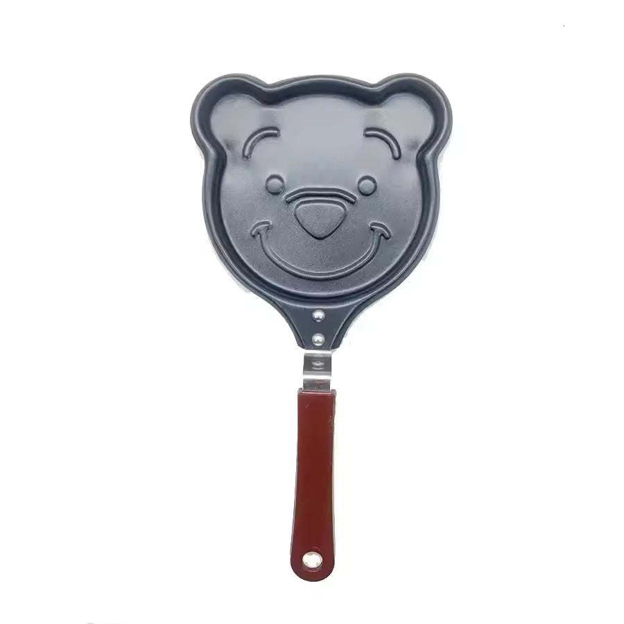 Creative cartoon mini omelette pan shaped like a smiling bear with a wooden handle from Clarify.pk