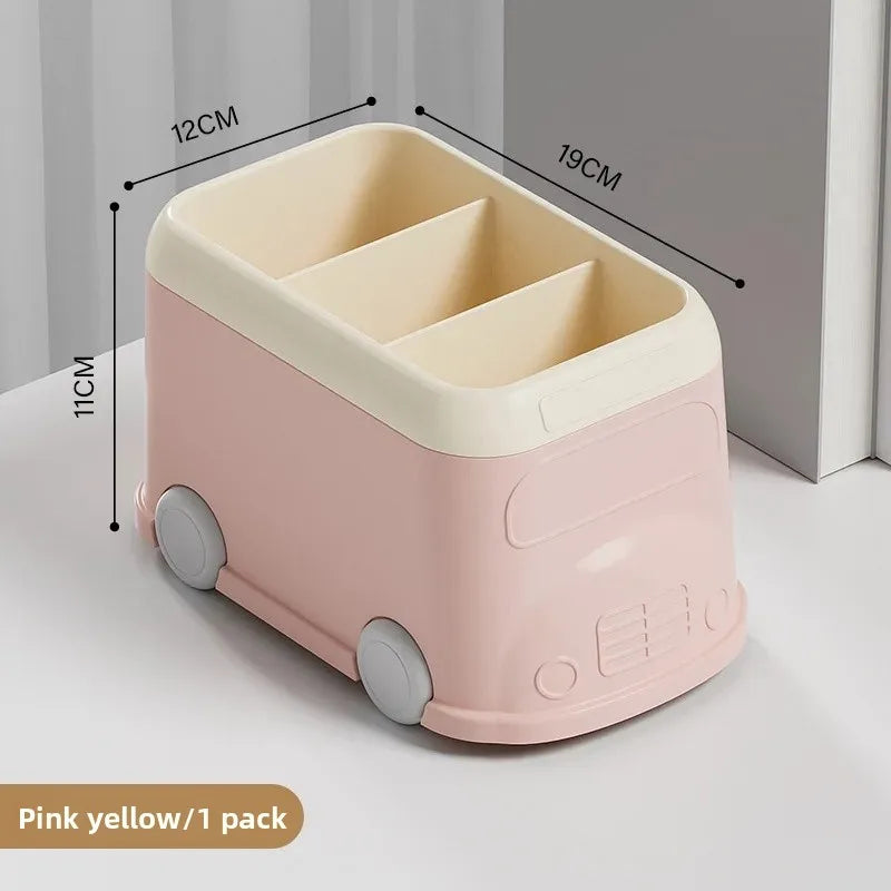 Creative desktop pen holder in pink and cream with three compartments and playful bus design