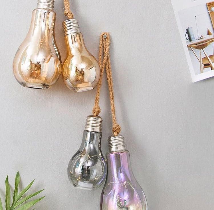 Creative hemp rope LED bulb set with decorative multicolor glass bulbs hanging on wall