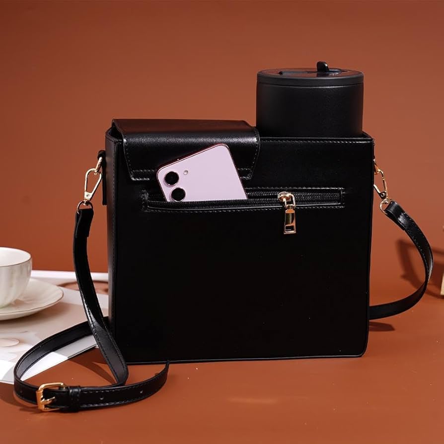 Black leather crossbody water bottle carrier bag with zip pocket holding a phone and insulated bottle