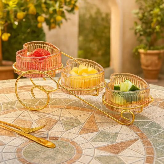 Crystal heart snack bowl set with three pink glass bowls on gold metal stand filled with snacks