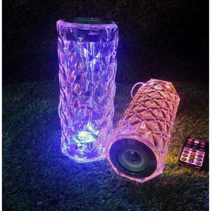 Crystal lamp with bluetooth speaker featuring colorful LED lights and remote control on grass