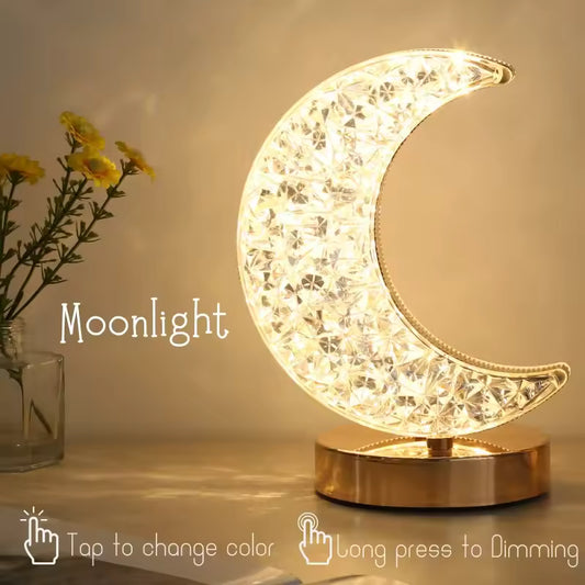 Crystal moon night light lamp glowing with warm white light on gold base by Clarify.pk