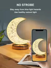 Crystal moon night light lamp on a wooden surface emitting warm natural light with no strobe effect